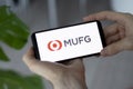 IRPEN, UKRAINE - JANUARY 20 20223, Closeup of smartphone screen MUFG Bank logo lettering with in man's hands