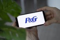 IRPEN, UKRAINE - JANUARY 20 20223, Closeup of smartphone screen P and G logo lettering with in man's hands