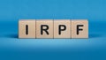 IRPF text on wooden block.