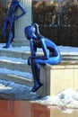 Blue statue of a thinking sitting girl on the central square, modern art