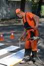 IRPIN, UKRAINE - MAY 06, 2017: Worker is painting a pedestrian crosswalk. Technical road man worker painting and remarking pedestr Royalty Free Stock Photo
