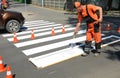 IRPIN, UKRAINE - MAY 06, 2017: Worker is painting a pedestrian crosswalk. Technical road man worker painting and remarking pedestr Royalty Free Stock Photo