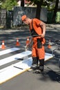 IRPIN, UKRAINE - MAY 06, 2017: Worker is painting a pedestrian crosswalk. Technical road man worker painting and remarking pedestr Royalty Free Stock Photo