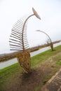 Metal statues of fish bones at the river bank, modern art Royalty Free Stock Photo