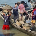 Burmese workers carrying sand