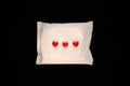 Irregular period concept. Menstrual cycle pad with red hearts on black background. Menorrhagia or heavy menstruation Royalty Free Stock Photo