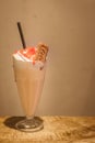 An irresistible duo of nutty and nice; peanut butter shake with strawberry jam and topped with whipped cream and a caramel biscuit Royalty Free Stock Photo