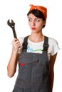 Irresolute girl with spanner Royalty Free Stock Photo