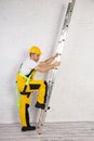 Irresponsible use of a ladder during construction work. Royalty Free Stock Photo