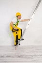 Irresponsible use of a ladder during construction work. Royalty Free Stock Photo