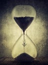 Irreversible time passing concept. Surreal painting with a tiny person falling among the sand inside hourglass. Human dependence Royalty Free Stock Photo