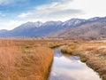 Irrigation canal leading towards snow capped mountains near Genoa Nevada. Royalty Free Stock Photo