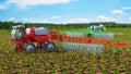 Irrigation machine among the field and under a blue sky sprays the water on plants, another irrigation machine on background, Royalty Free Stock Photo