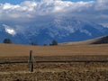 Irrigation Pipe, Field and Snowcapped Mountains Royalty Free Stock Photo