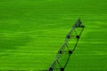 Irrigation Pivot in Lush Green Field with Circle Tracks on Ground