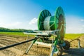 Irrigation system for watering of agricultural crops with a big hose reel. Large industrial equipment for irrigation. Agriculture,