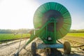 Irrigation system for watering of agricultural crops with a big hose reel. Large industrial equipment for irrigation. Agriculture,