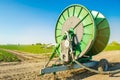 Irrigation system for watering of agricultural crops with a big hose reel. Large industrial equipment for irrigation. Agriculture,