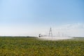 Irrigation System Watering Crops on Farm Field Royalty Free Stock Photo