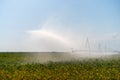 Irrigation System Watering Crops on Farm Field Royalty Free Stock Photo