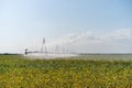 Irrigation System Watering Crops on Farm Field Royalty Free Stock Photo