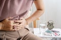 irritable bowel syndrome IBS concept with woman hand holding a stomachache Royalty Free Stock Photo