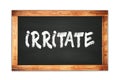 IRRITATE text written on wooden frame school blackboard