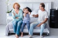 Irritated aged couple quarreling in front of their granddaughter