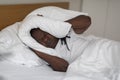 Irritated Black Man Lying In Bed And Covering Ears With Pillow Royalty Free Stock Photo