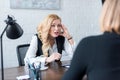 irritated businesswoman looking at coworker