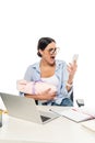 irritated businesswoman screaming while holding smartphone