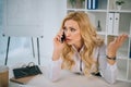 irritated businesswoman talking by smartphone