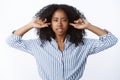 Irritated fed up pissed furious african american woman annoyed hearing loud disturbing noise put index fingers ear holes