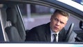 Irritated male driver looking out of car window, annoying traffic jam, accident Royalty Free Stock Photo