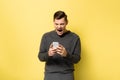 Irritated man screaming while using cellphone Royalty Free Stock Photo