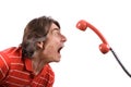 Irritated man screams into the telephone receiver Royalty Free Stock Photo