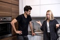 irritated married couple having quarrel, yelling at each other in kitchen at home Royalty Free Stock Photo