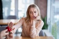 Irritated millennial woman not accepting engagement ring from her boyfriend, rejecting marriage offer at coffee shop Royalty Free Stock Photo