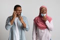 Irritated muslim black couple removing face masks to breathe