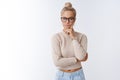 Irritated and pissed glamour woman with blond hair in glasses being annoyed with wasted time touching cheek folding lips