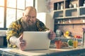 Irritated thick guy watching something on laptop