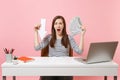 Irritated woman screaming holding down value fall arrow bundle lots of dollars cash money work at white desk with pc Royalty Free Stock Photo