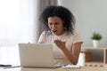 Irritated woman swears at broken or hanging out computer Royalty Free Stock Photo