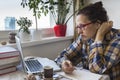 Irritated woman working on a laptop at home. Internet troll. Royalty Free Stock Photo