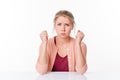 Irritated young blond woman puffing out her cheeks for exasperation Royalty Free Stock Photo