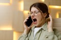 Irritated young woman screaming into the phone Royalty Free Stock Photo