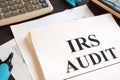 IRS Audit report and calculator on a desk. Royalty Free Stock Photo