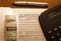 IRS blank 1040 income tax form close up with aspirin bottle and calculator
