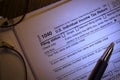 IRS blank 1040 income tax form close up with ball point pen and reading glasses Royalty Free Stock Photo