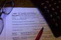 IRS blank 1040 income tax form close up with calculator